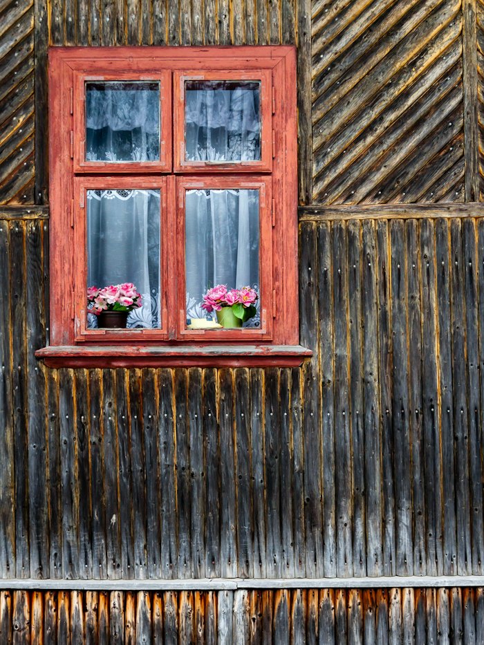 Painted wood window frame set in a timber wall